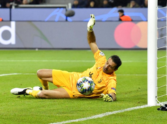 Juventus' goalkeeper Gianluigi Buffon makes a save during the Champions League Group D soccer match between Bayer Leverkusen and Juventus at the BayArena in Leverkusen, Germany, Wednesday, Dec. 11, 2019. (AP Photo/Martin Meissner)