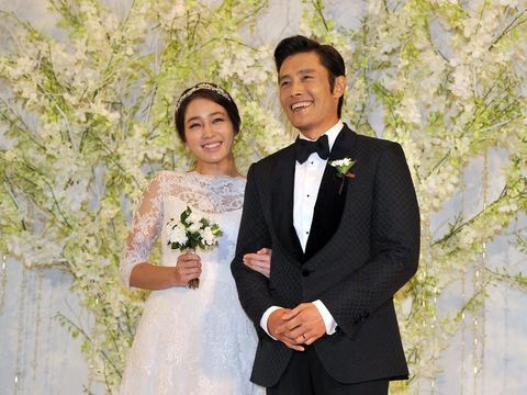 South Korean actor Lee Byung-Hun (R) poses with actress Rhee Min-Jung (L) during a press conference before their wedding in Seoul on August 10, 2013. Lee Byung-Hun is one of the best known faces of the 