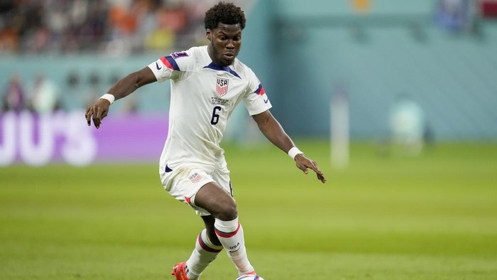 FILE - Yunus Musah of the United States dribbles the ball during their World Cup soccer match against the Netherlands, at the Khalifa International Stadium in Doha, Qatar, Saturday, Dec. 3, 2022. Musah is following United States teammate Christian Pulisic to American-owned AC Milan. Musah, who was born in New York but grew up in Italy and England, signed a five-year contract with the Rossoneri on Friday, Aug. 4, 2023 following a transfer from Valencia. (AP Photo/Ashley Landis, file)