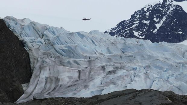 A helicopter flies over the Mendenhall Glacier on June 8, 2023, in Juneau, Alaska. The glacier in the summer is accessible by kayak or canoe, by foot or by helicopter. As the Mendenhall Glacier continues to recede, tourists are flooding into Juneau. A record number of cruise ship passengers are expected this year in the city of about 30,000 people. (AP Photo/Becky Bohrer)