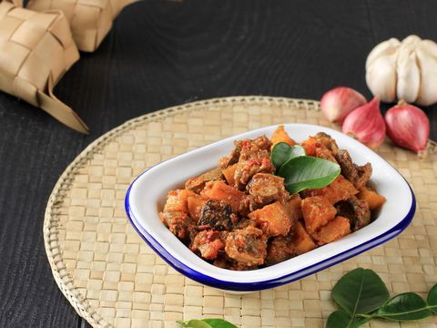 Sambal Goreng Hati Kentang or Hot Spicy Liver and Potatoes, Indonesian Traditional Cuisine, Typically Served During Eid Al Fitr Celebration with Ketupat.