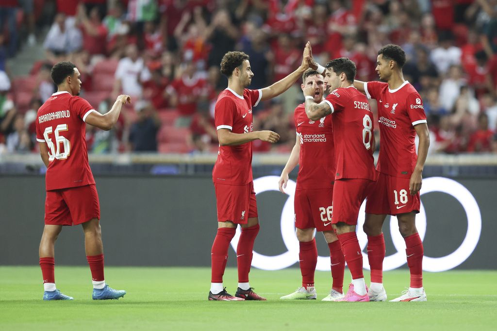 Cody Gakpo of Liverpool FC celebrates with his team mates after scoring the first opening goal during the preseason friendly football match between Liverpool Fc and FC Bayern Munchen in Singapore, Tuesday, August 2nd, 2023. (AP Photo/Danial Hakim)