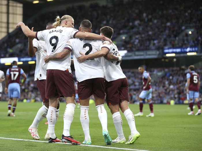 Manchester Citys Erling Haaland celebrates scoring their sides second goal of the game with team-mates during the Premier League soccer match between Manchester City and Burnley FC at Turf Moor, Burnley, England, Friday Aug. 11, 2023. (Nigel French/PA via AP)