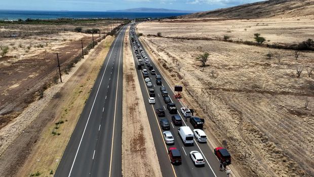 WAILUKU, HAWAII - AUGUST 11: In an aerial view, cars back up for miles on the Honoapiilani highway as residents are allowed back into areas affected by the recent wildfire on August 11, 2023 in Wailuku, Hawaii. Dozens of people were killed and thousands were displaced after a wind-driven wildfire devastated the town of Lahaina on Tuesday. Crews are continuing to search for missing people.   Justin Sullivan/Getty Images/AFP (Photo by JUSTIN SULLIVAN / GETTY IMAGES NORTH AMERICA / Getty Images via AFP)