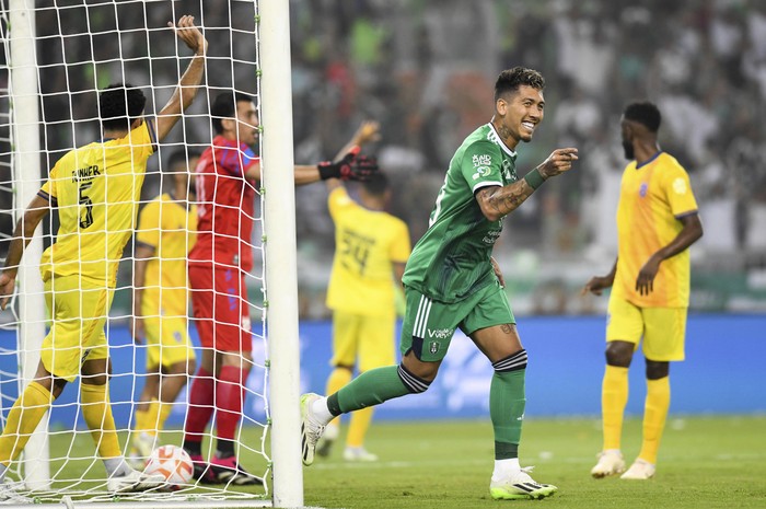 Al-Ahli player Roberto Firmino celebrates during his team match against Al-Hazm on the Saudi Pro League (SPL) at Prince Abdullah al-Faisal Stadium in Jeddah, Saudi Arabia, Friday, Aug. 11, 2023.  (AP Photo/Jameel)