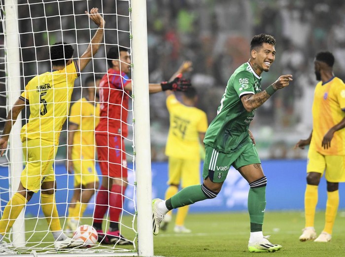 Al-Ahli player Roberto Firmino celebrates during his team match against Al-Hazm on the Saudi Pro League (SPL) at Prince Abdullah al-Faisal Stadium in Jeddah, Saudi Arabia, Friday, Aug. 11, 2023.  (AP Photo/Jameel)