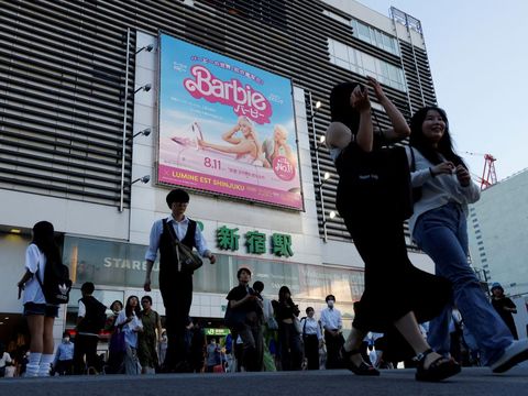 FILE PHOTO: People walk past promotional poster of film 