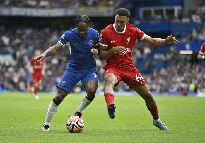 Soccer Football - Premier League - Chelsea v Liverpool - Stamford Bridge, London, Britain - August 13, 2023 Chelseas Raheem Sterling in action with Liverpools Trent Alexander-Arnold REUTERS/Tony Obrien EDITORIAL USE ONLY. No use with unauthorized audio, video, data, fixture lists, club/league logos or live services. Online in-match use limited to 75 images, no video emulation. No use in betting, games or single club /league/player publications.  Please contact your account representative for further details.