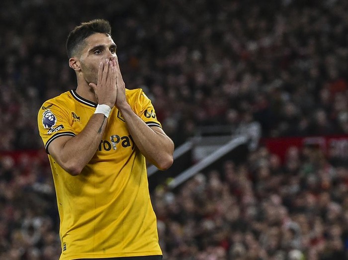 Wolverhampton Wanderers' Pedro Neto reacts after Manchester United's Raphael Varane scores his side's opening goal during the English Premier League soccer match between Manchester United and Wolverhampton at the Old Trafford stadium in Manchester, England, Monday, Aug. 14, 2023. (AP Photo/Rui Vieira)