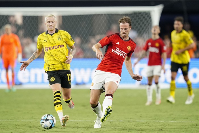 Jul 30, 2023; Las Vegas, Nevada, USA; Manchester United defender Jonny Evans (27) moves the ball against Borussia Dortmund midfielder Marco Reus (11) during the second half at Allegiant Stadium. Mandatory Credit: Lucas Peltier-USA TODAY Sports