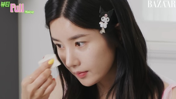 Portrait of Kwon Eun Bi putting on makeup in a photoshoot with Harper's BAZAAR