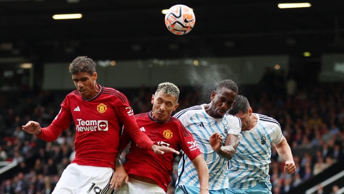 Soccer Football - Premier League - Manchester United v Nottingham Forest - Old Trafford, Manchester, Britain - August 26, 2023 Manchester Uniteds Lisandro Martinez and Raphael Varane in action with Nottingham Forests Willy Boly and Scott McKenna Action Images via Reuters/Lee Smith EDITORIAL USE ONLY. No use with unauthorized audio, video, data, fixture lists, club/league logos or live services. Online in-match use limited to 75 images, no video emulation. No use in betting, games or single club /league/player publications.  Please contact your account representative for further details.