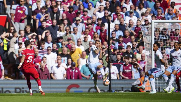 Liverpool's Dominik Szoboszlai scores his side's first goal during the English Premier League soccer match between Liverpool and Aston Villa at Anfield stadium in Liverpool, Sunday, Sept 3, 2023. (AP Photo/Jon Super)