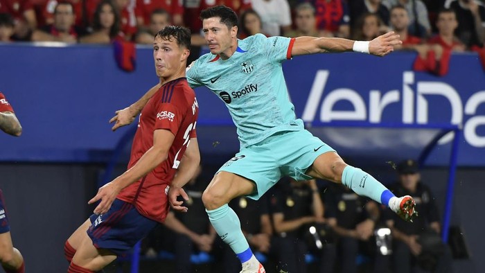 Barcelonas Robert Lewandowski, center, watches the ball after attempting a shot on goal during Spanish La Liga soccer match between Osasuna and Barcelona at El Sadar stadium in Pamplona, Spain, Sunday, Sept. 3, 2023. (AP Photo/Alvaro Barrientos)