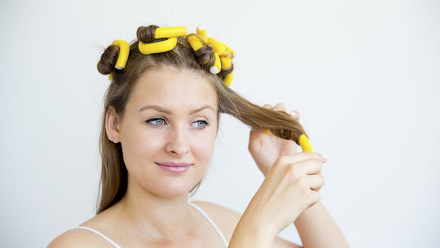 A portrait of a girl taking care of her hair