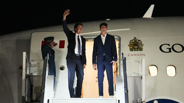 Canadian Prime Minister Justin Trudeau, center, and his son, Xavier, depart Ottawa, Ontario, on Sunday, Sept. 3, 2023. Trudeau will travel to Indonesia, Singapore and India. (Sean Kilpatrick/The Canadian Press via AP)