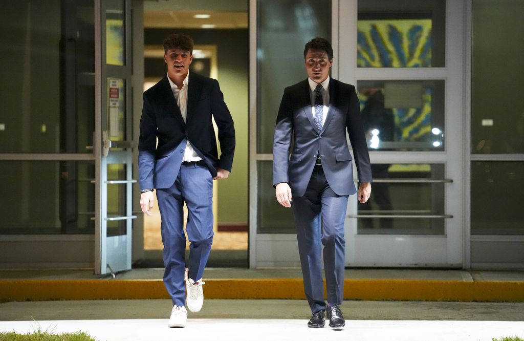 Canadian Prime Minister Justin Trudeau, center, and his son, Xavier, depart Ottawa, Ontario, on Sunday, Sept. 3, 2023. Trudeau will travel to Indonesia, Singapore and India. (Sean Kilpatrick/The Canadian Press via AP)