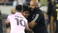 Fans itu berlari ke arah Lionel Messi dan mencoba memeluk LM10. Keinginannya itu batal terwujud setelah Yassine Chueko berlari dan menangkapnya. (AP Photo/Mark J. Terrill)  
