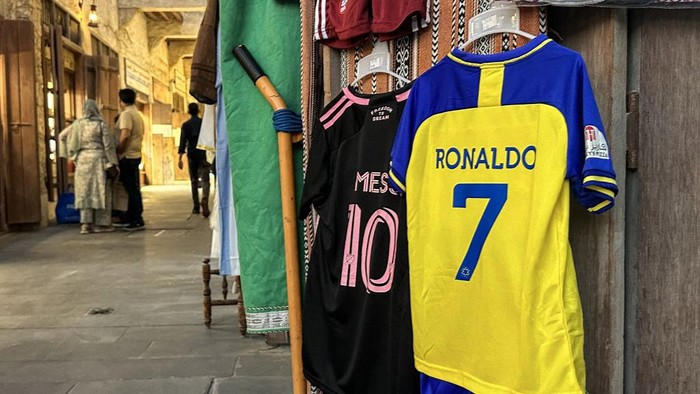 The football jerseys of Portugals forward #7 Cristiano Ronaldo with his new Saudi club al-Nassr and Argentinas forward #10 Lionel Messi with his new US club Inter Miami CF are displayed for sale at a vendors stall at Qatars touristic Souq Waqif bazar in Doha on August 7, 2023. (Photo by KARIM JAAFAR / AFP)