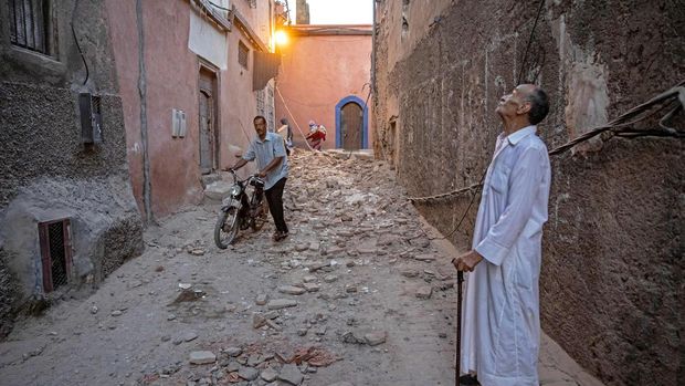 A resident looks at a damaged building. Fadel Senna/AFP/Getty Images