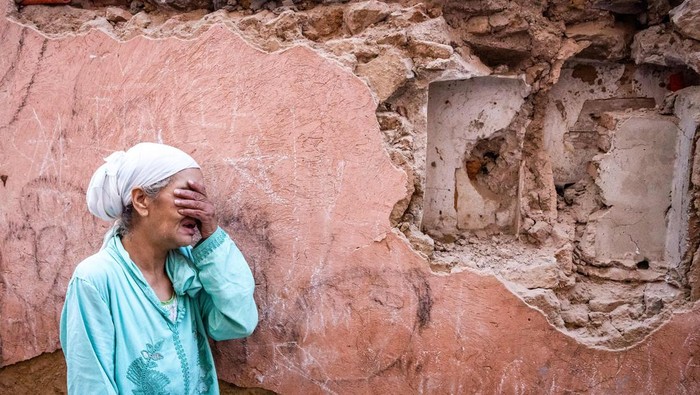 A woman reacts standing in front of her earthquake-damaged house. Fadel Senna/AFP/Getty Images