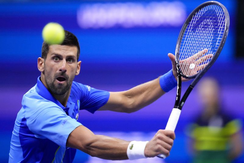 Novak Djokovic, of Serbia, holds up the championship trophy after defeating Daniil Medvedev, of Russia, in the men's singles final of the U.S. Open tennis championships, Sunday, Sept. 10, 2023, in New York. (AP Photo/Manu Fernandez)