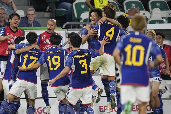Japan players celebrate after Japans Ao Tanaka scored his sides fourth goal during an international friendly soccer match between Germany and Japan in Wolfsburg, Germany, Saturday, Sept. 9, 2023. (AP Photo/Martin Meissner)