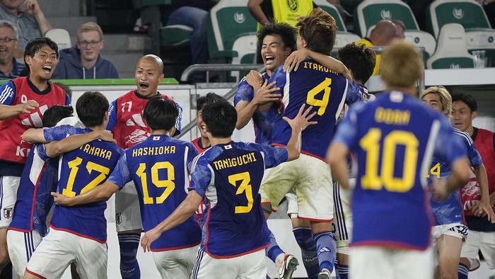 Japan players celebrate after Japans Ao Tanaka scored his sides fourth goal during an international friendly soccer match between Germany and Japan in Wolfsburg, Germany, Saturday, Sept. 9, 2023. (AP Photo/Martin Meissner)
