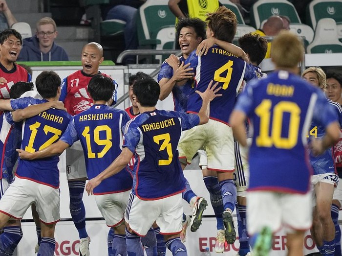 Japan players celebrate after Japan's Ao Tanaka scored his side's fourth goal during an international friendly soccer match between Germany and Japan in Wolfsburg, Germany, Saturday, Sept. 9, 2023. (AP Photo/Martin Meissner)