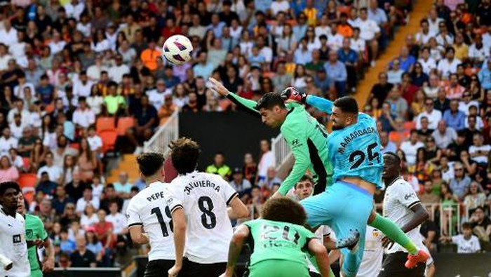 Atletico Madrids Spanish forward #19 Alvaro Morata vies with Valencias Georgian goalkeeper #25 Giorgi Mamardashvili (R) during the Spanish Liga football match between Valencia CF and Club Atletico de Madrid at the Mestalla stadium in Valencia on September 16, 2023. (Photo by Jose Jordan / AFP)