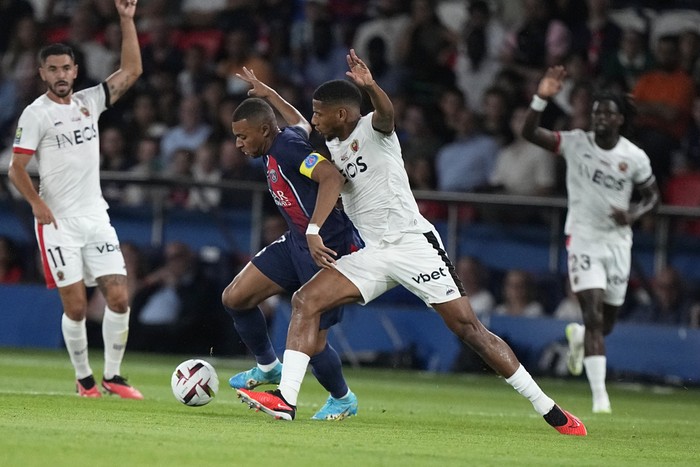 PSG's Kylian Mbappe, second from left, challenges for the ball with Nice's Jean-Clair Todibo during the French League One soccer match between Paris Saint Germain and Nice at Parc des Princes stadium in Paris, Friday, Sept. 15, 2023. (AP Photo/Michel Euler)