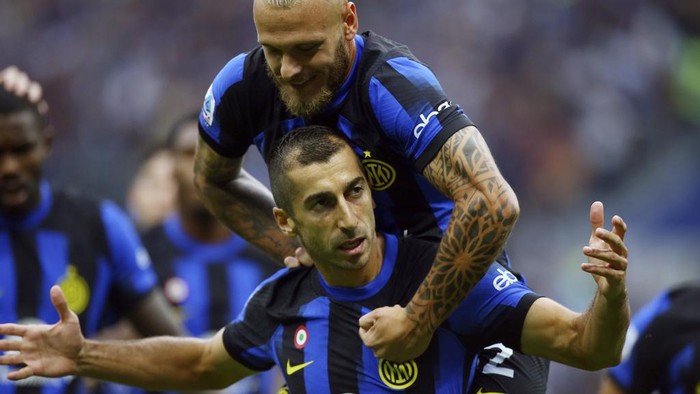 Inter Milans Henrikh Mkhitaryan celebrates with teammate Federico Dimarco, top, after scoring the opening goal during a Serie A soccer match between Inter Milan and AC Milan at the San Siro stadium in Milan, Italy, Saturday, Sept.16, 2023. (Spada//LaPresse via AP)