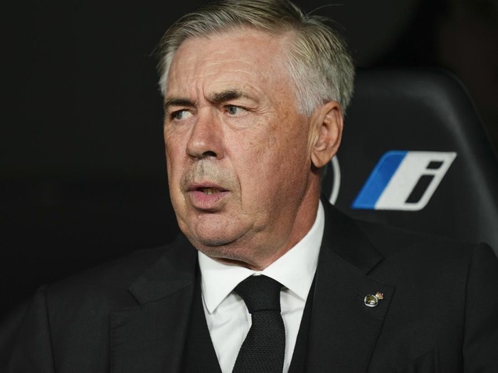 Real Madrids head coach Carlo Ancelotti sits at the bench prior to Spanish La Liga soccer match between Real Madrid and Real Sociedad at the Santiago Bernabéu stadium in Madrid, Spain, Sunday, Sept. 17, 2023. (AP Photo/Jose Breton)