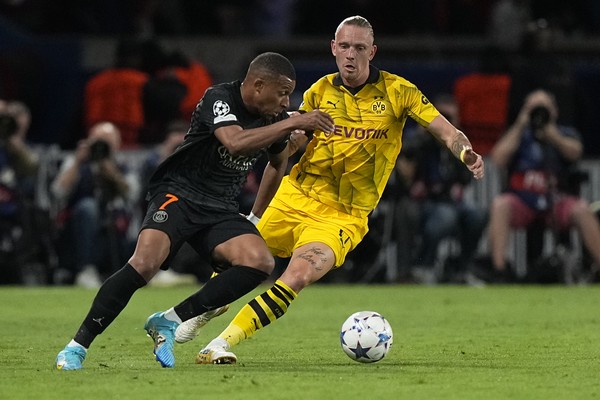 PSGs Kylian Mbappe, left, is challenged by Dortmunds Marius Wolf during the Champions League group F soccer match between Paris Saint-Germain and Borussia Dortmund, at the Parc des Princes stadium in Paris, France, Tuesday, Sept. 19, 2023. (AP Photo/Michel Euler)