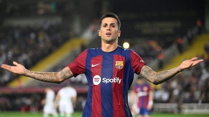 Barcelonas Portuguese defender #02 Joao Cancelo celebrates after scoring his teams fifth goal during the Spanish Liga football match between FC Barcelona and Real Betis at the Estadi Olimpic Lluis Companys in Barcelona on September 16, 2023. (Photo by Josep LAGO / AFP)