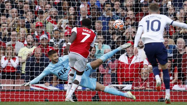 Arsenal's Bukayo Saka scores his side's second goal from the penalty spot past Tottenham's goalkeeper Guglielmo Vicario during the English Premier League soccer match between Arsenal and Tottenham Hotspur at Emirates stadium in London, England, Sunday, Sept. 24, 2023. (AP Photo/David Cliff)