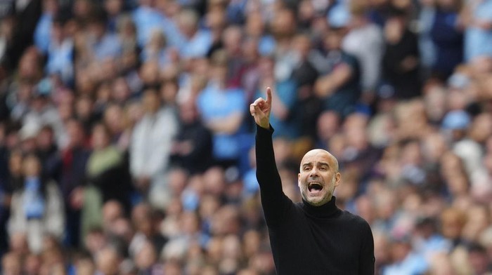 Manchester Citys head coach Pep Guardiola gestures during the English Premier League soccer match between Manchester City and Nottingham Forest at Etihad stadium in Manchester, England, Saturday, Sept. 23, 2023. (AP Photo/Jon Super)