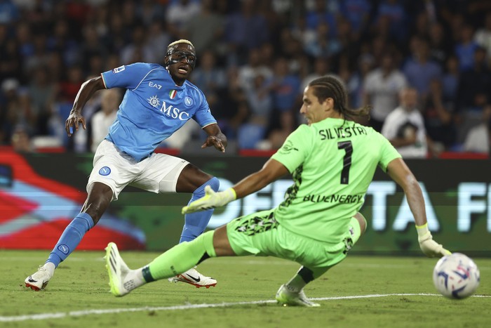 Napolis Victor Osimhen, left, scores their sides second goal of the game during the Serie A soccer match between Napoli and Udinese at the Diego Armando Maradona stadium in Naples, Italy, Wednesday Sept. 27, 2023. (Alessandro Garofalo/LaPresse via AP)
