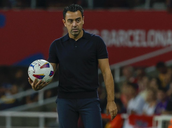 Barcelonas head coach Xavi Hernandez holds the ball during a Spanish La Liga soccer match between Barcelona and Sevilla, at the Olympic Stadium of Montjuic in Barcelona, Spain, Friday, Sept. 29, 2023. (AP Photo/Joan Monfort)
