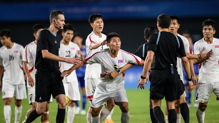 North Koreas Kim Kyongsok (C) reacts during the mens quarter-final football match between North Korea and Japan at the Hangzhou 2022 Asian Games in Hangzhou, in Chinas eastern Zhejiang province on October 1, 2023. (Photo by Philip FONG / AFP)