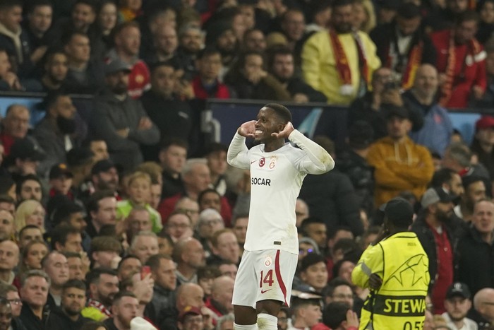 Galatasaray's Wilfried Zaha celebrates after scoring his side's opening goal during the Champions League group A soccer match between Manchester United and Galatasaray at the Old Trafford stadium in Manchester, England, Tuesday, Oct. 3, 2023. (AP Photo/Dave Thompson)