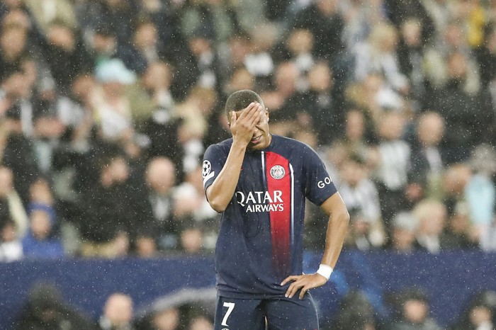 PSGs Kylian Mbappe touches his face during the Champions League group F soccer match between Newcastle and Paris Saint Germain at St. James Park, Wednesday, Oct. 4, 2023, in Newcastle, England. (AP Photo/Scott Heppell)