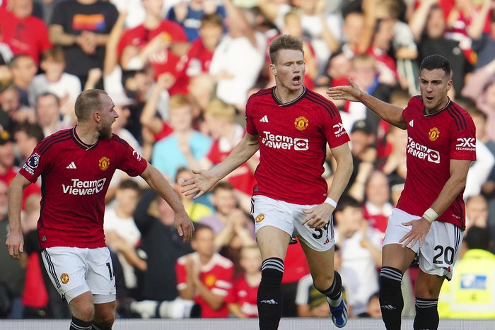 Manchester Uniteds Scott McTominay, centre, celebrates scoring his sides first goal during the English Premier League soccer match between Manchester United and Brentford at the Old Trafford stadium in Manchester, England, Saturday, Oct. 7, 2023.(AP Photo/Jon Super)