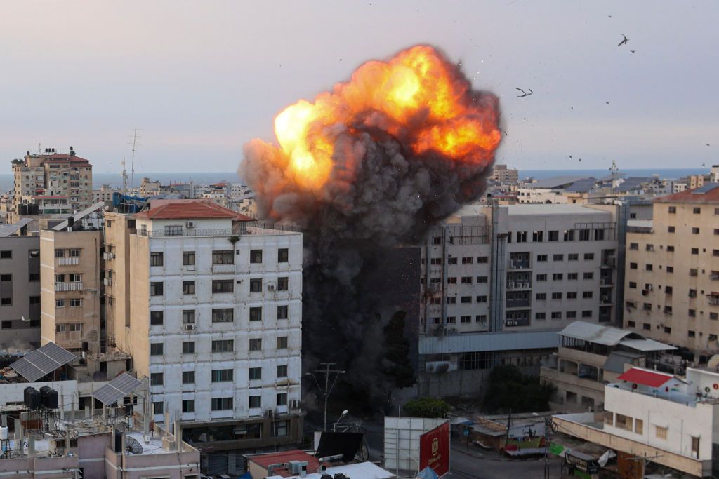 TOPSHOT - Fire and smoke rise after an Israeli air strike targeted the National Bank on Gaza City, on October 8, 2023. Israel, reeling from the deadliest attack on its territory in half a century, formally declared war on Hamas Sunday as the conflict's death toll neared 1,000 after the Palestinian militant group launched a massive surprise assault from Gaza. (Photo by Ahmed ZAKOUT / AFP) (Photo by AHMED ZAKOUT/AFP via Getty Images)