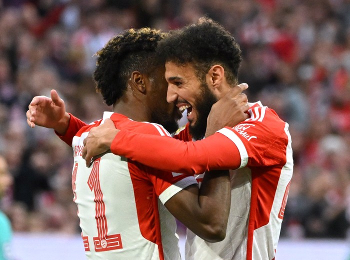 Noussair Mazraoui Soccer Football - Bundesliga - Bayern Munich v SC Freiburg - Allianz Arena, Munich, Germany - October 8, 2023 Bayern Munich's Kingsley Coman celebrates scoring their first goal with teammate Noussair Mazraoui REUTERS/Angelika Warmuth DFL REGULATIONS PROHIBIT ANY USE OF PHOTOGRAPHS AS IMAGE SEQUENCES AND/OR QUASI-VIDEO.