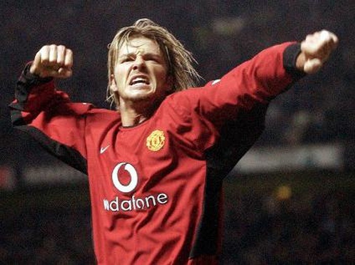 Manchester United's David Beckham celebrates after his shot was rebounded into the goal by Ruud van Nistelrooy against Leeds United during their premiereship clash at Old Trafford in Manchester 05 March 2003. AFP Photo by Paul Barker (Photo by PAUL BARKER / AFP)