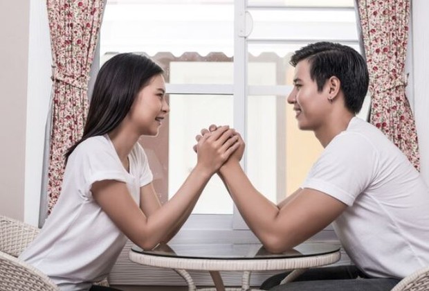 Perempuan dan laki-laki sedang berpegangan tangan