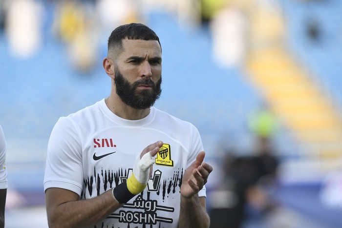 Al Ittihads Karim Benzema greets fans during his team match against Al Raed in the Saudi Professional League, in Buraidah, Saudi Arabia, Monday, Aug. 14, 2023. (AP Photo)