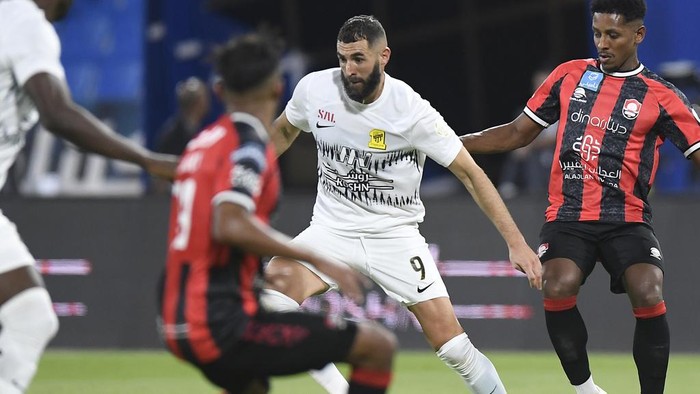 FILE - Al Ittihads Karim Benzema, center, fights for the ball during his team match against Al Raed in Saudi Professional League, in Buraidah, Saudi Arabia, Monday, Aug. 14, 2023. Cristiano Ronaldo, Neymar and Karim Benzema have won a combined total of 11 UEFA Champions League titles and, starting Monday, Sept. 18, 2023, they lead the Saudi Arabian challenge in the Asian edition.(AP Photo/File)