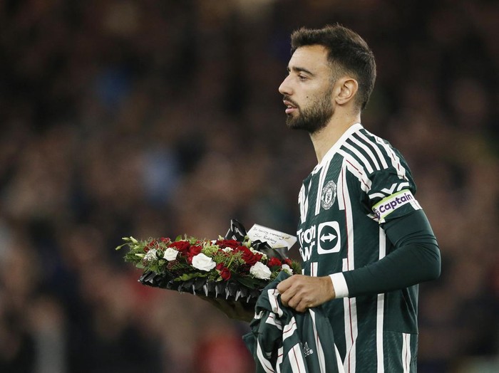 Soccer Football - Premier League - Sheffield United v Manchester United - Bramall Lane, Sheffield, Britain - October 21, 2023 Manchester United's Bruno Fernandes lays down a wreath following the passing of former Manchester United player Bobby Charlton REUTERS/Ed Sykes NO USE WITH UNAUTHORIZED AUDIO, VIDEO, DATA, FIXTURE LISTS, CLUB/LEAGUE LOGOS OR 'LIVE' SERVICES. ONLINE IN-MATCH USE LIMITED TO 45 IMAGES, NO VIDEO EMULATION. NO USE IN BETTING, GAMES OR SINGLE CLUB/LEAGUE/PLAYER PUBLICATIONS.